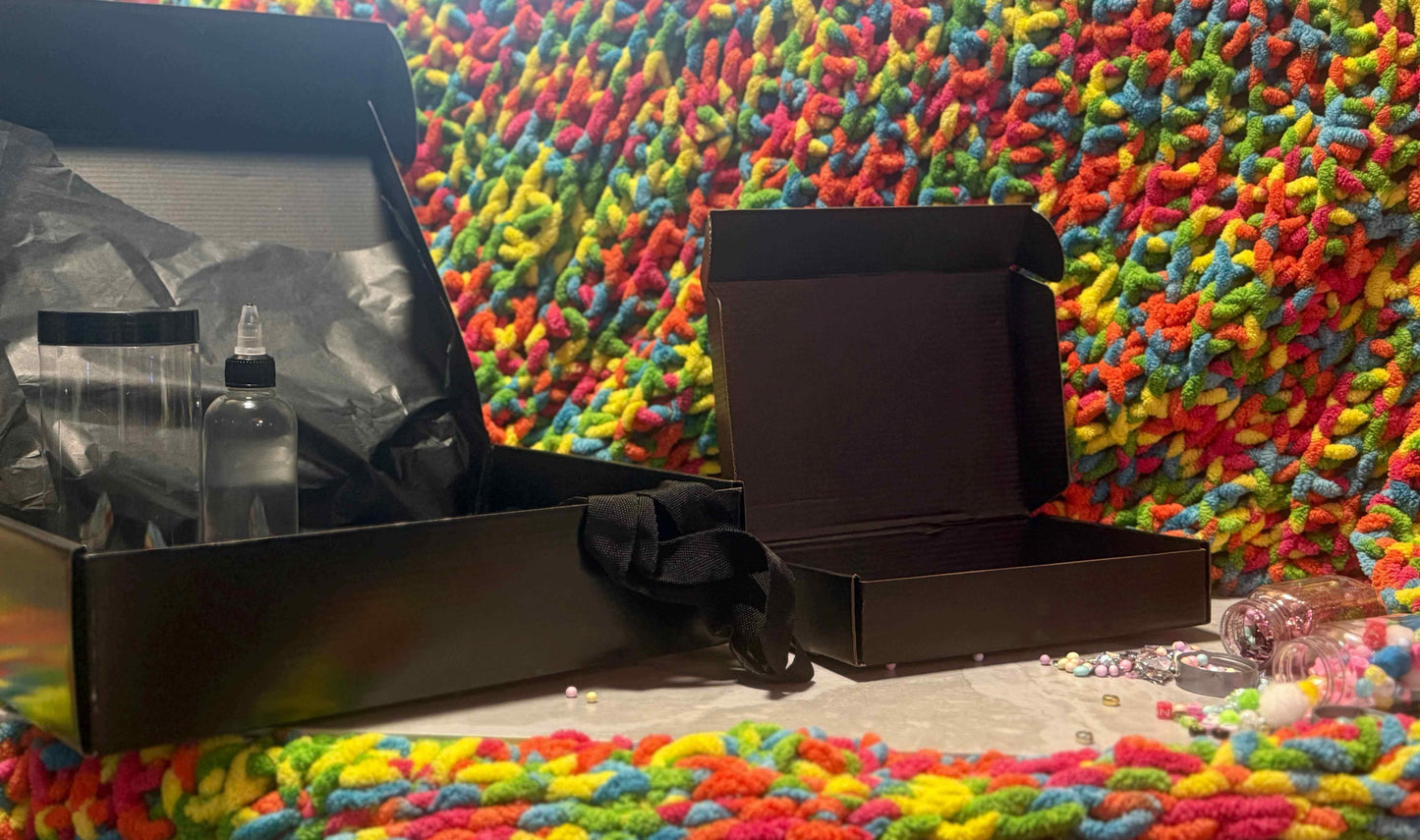 Wild Christmas Sensory Bottle Kit components including bottles and empty boxes on a colorful textured background.